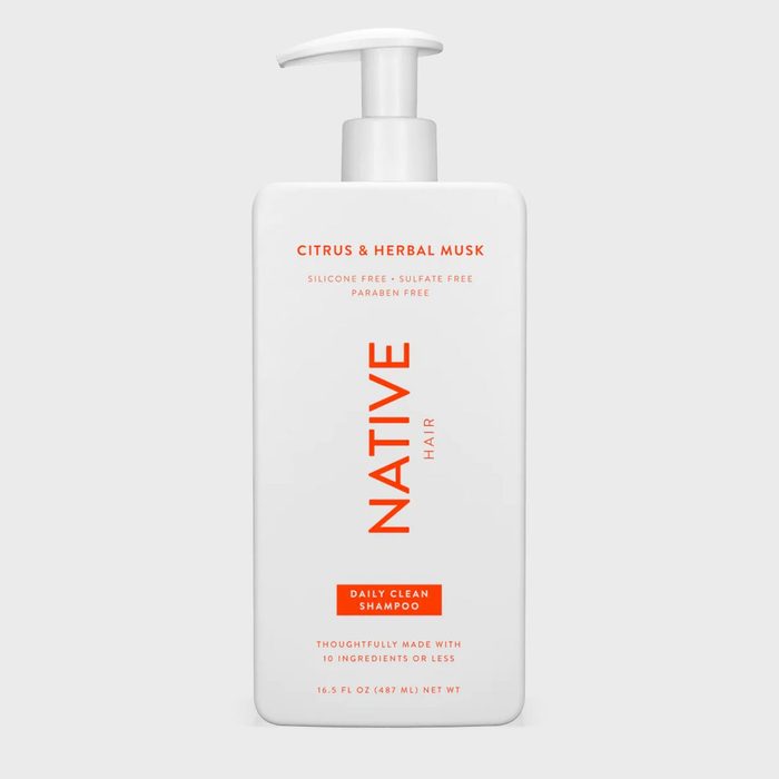 White shampoo bottle with pump, featuring bold orange text 