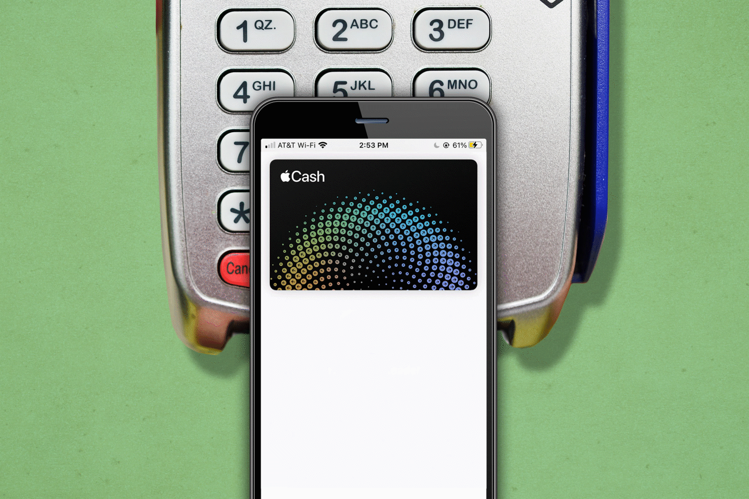 Smartphone displays Apple Cash, resting on a payment terminal keypad. Green background provides context for a digital transaction in progress.