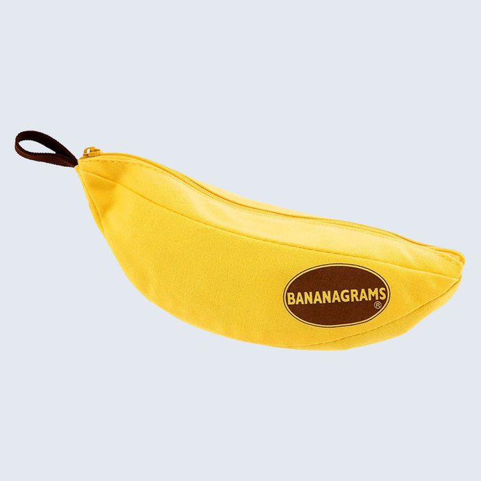A banana-shaped yellow fabric pouch with a zipper lies on a light gray background. Text reads 