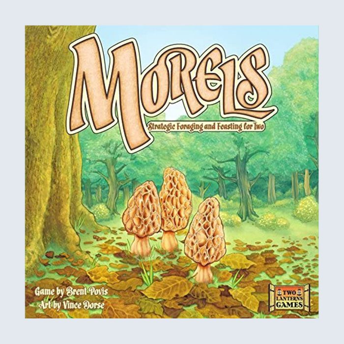 Three morel mushrooms stand amidst fallen leaves in a lush forest setting; text reads 