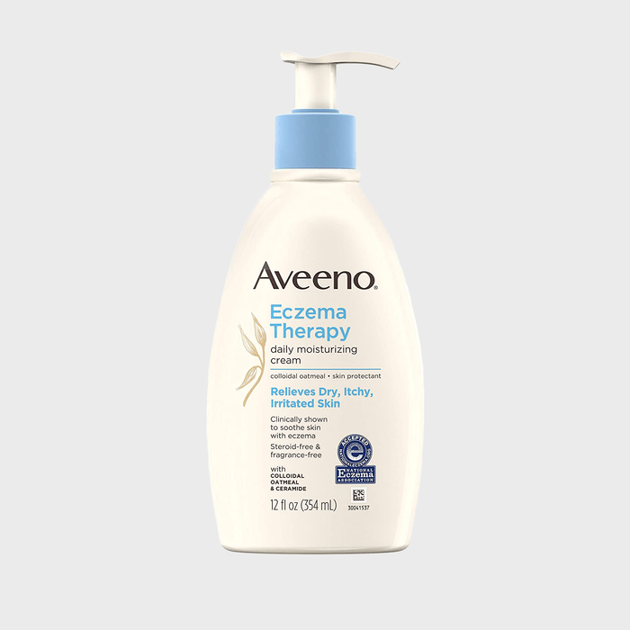 Bottle dispenses eczema therapy cream; labeled to relieve dry, itchy skin. Set against a plain gray background.