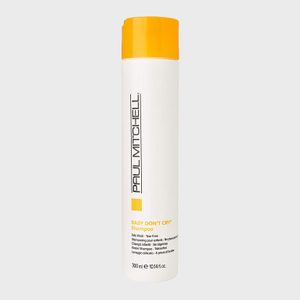 A white cylindrical shampoo bottle stands upright against a plain background, featuring 