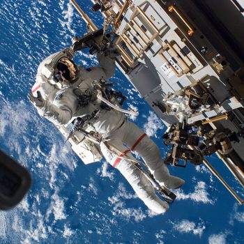 Astronaut repairs spacecraft in space, with Earth visible below, surrounded by equipment and tools.