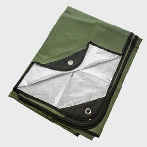Green tarp with reinforced edges, showing a corner folded back revealing reflective silver lining, against a plain background.