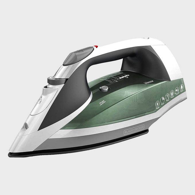 Iron sits idle on a gray background, featuring a green water tank and a white handle with multiple control symbols displayed.