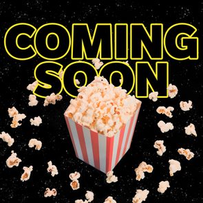 Popcorn is in a striped container, scattered against a starry black background, with 