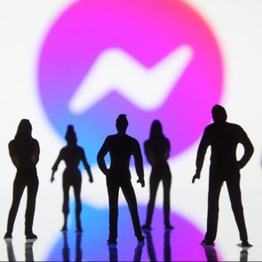 Silhouetted figures stand still against a gradient background with a stylized white lightning bolt icon within a circle in the center.