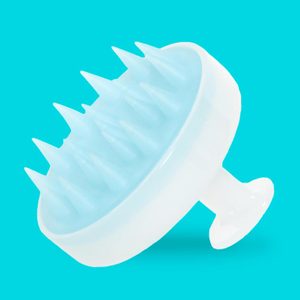 Round scalp massager with firm silicone bristles sits tilted against a bright turquoise background, emphasizing its ergonomic handle and soothing design.
