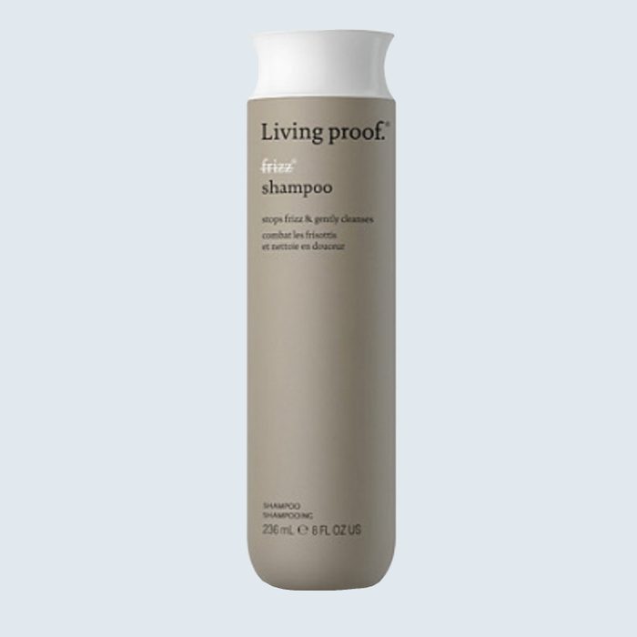 Shampoo bottle stands against a light blue background; text reads 
