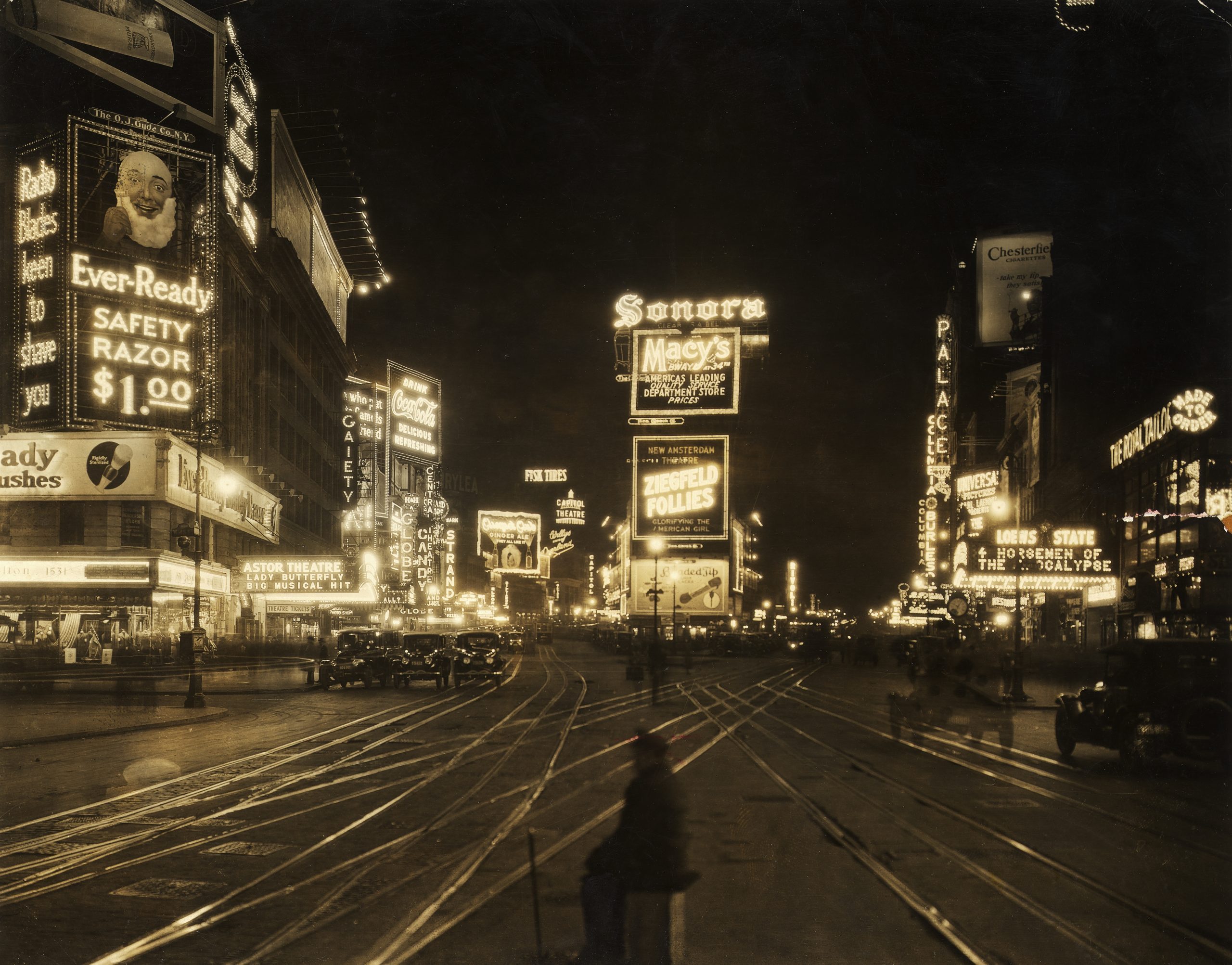 1921: View of the traffic and illuminated advertisements in Times Square at night, seen from 45th Street looking northward, New York City.