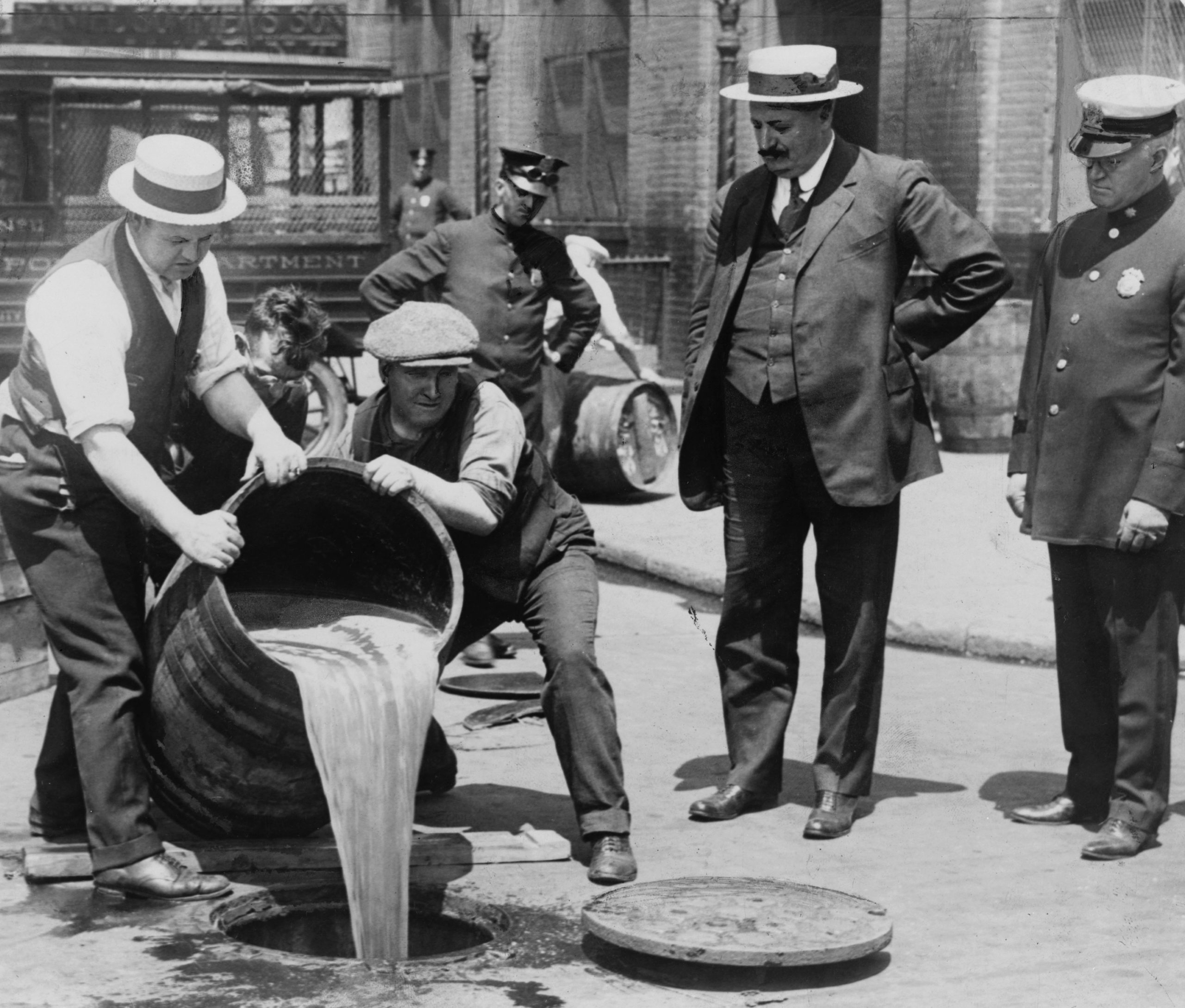 Pouring out illegal alcohol into a Sewer