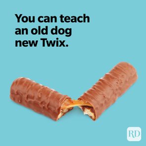 Twix bar breaks, revealing caramel, against a blue background with text: 
