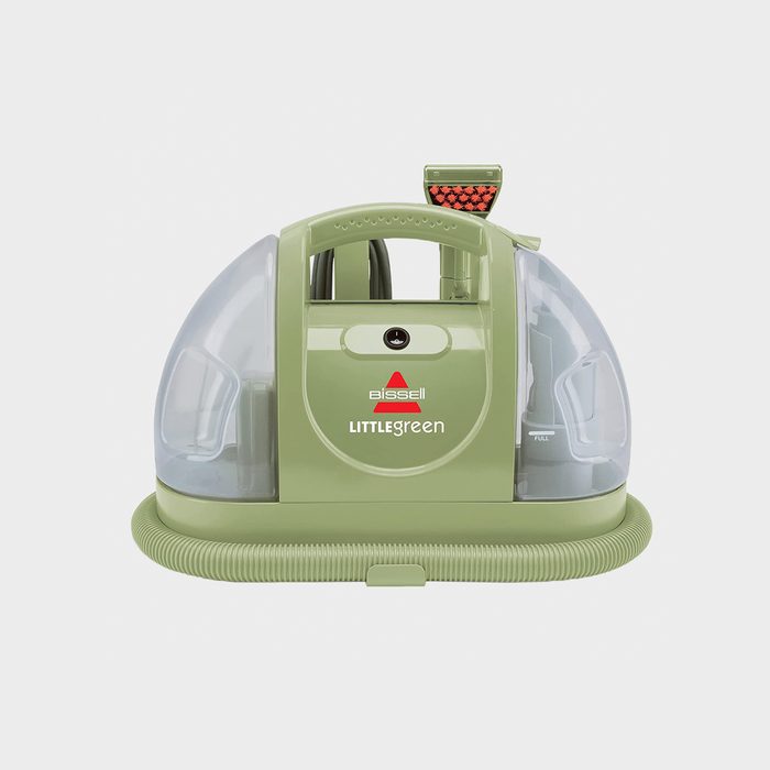 Green portable carpet cleaner with transparent tanks, resting on a white background. Text says 