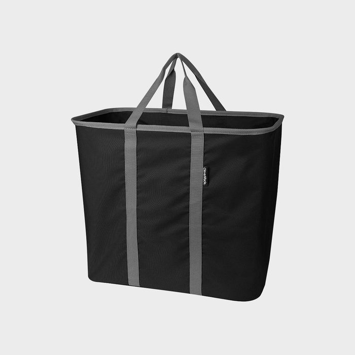 Black tote bag stands upright with grey handles, in a plain light grey background.