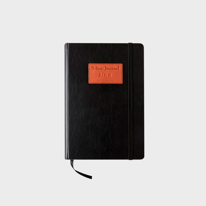 Journal lies closed with a leather cover and ribbon bookmark; 
