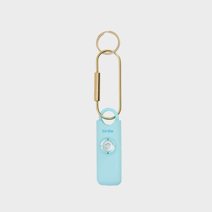 A light blue personal alarm with a button and text 