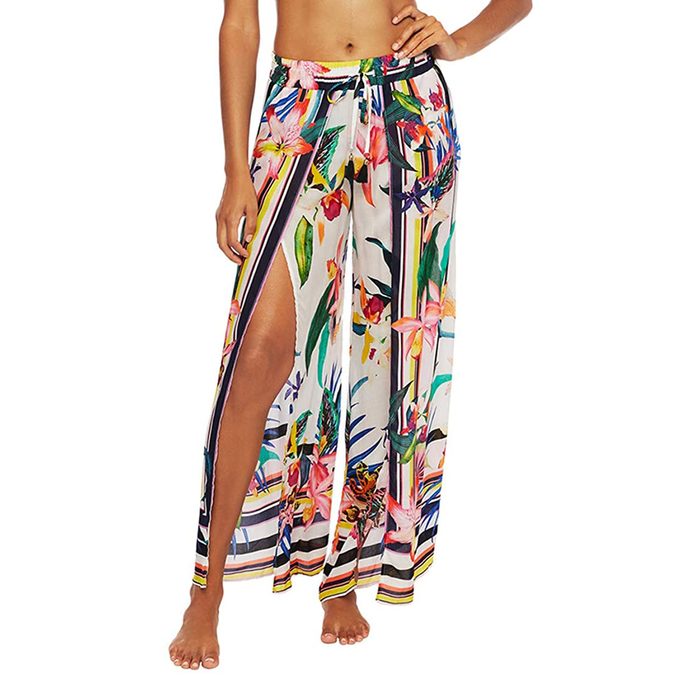 Skirt drapes with floral pattern and side slit, worn by standing figure; bright colors create a tropical, beachwear look.