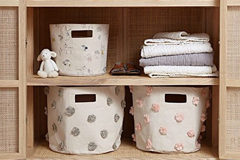 bins in an organized kids closet