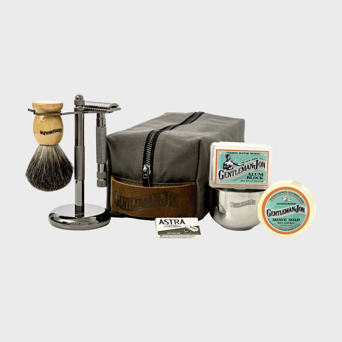 Shaving set includes a brush, razor, alum block, soap, and case, arranged neatly; text includes 