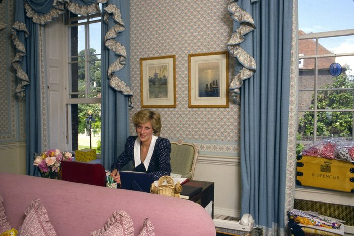 Princess Diana At Her Desk In Her Sitting Room At Home In Kensington Palace, London. Beside Her Is Her School Tuckbox With The Name D.spencer.