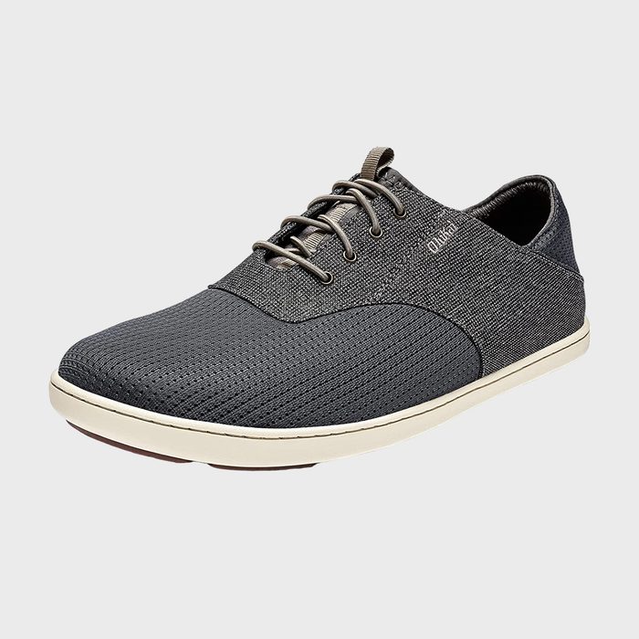Gray sneaker with textured design sits on a plain background, featuring laces and a white sole.