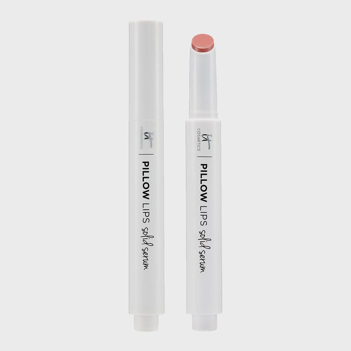 Lip balm tubes stand upright, one capped, one open, revealing soft pink balm, labeled 