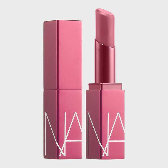 Pink lipstick opened next to its closed cap, with 