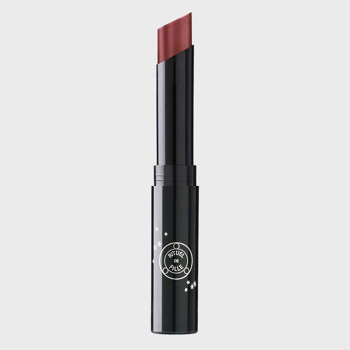Lipstick extends from a black cylindrical case with 
