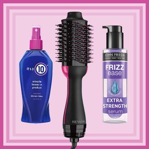 A black and pink hair dryer brush is flanked by a blue leave-in conditioner and a purple frizz ease serum, set against a pink background.
