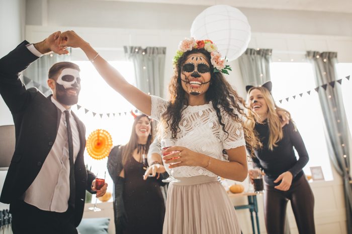 people in costume celebrating a halloween party with a costume contest