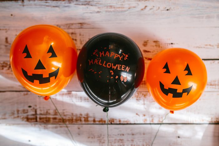 orange and black halloween balloons against a wall