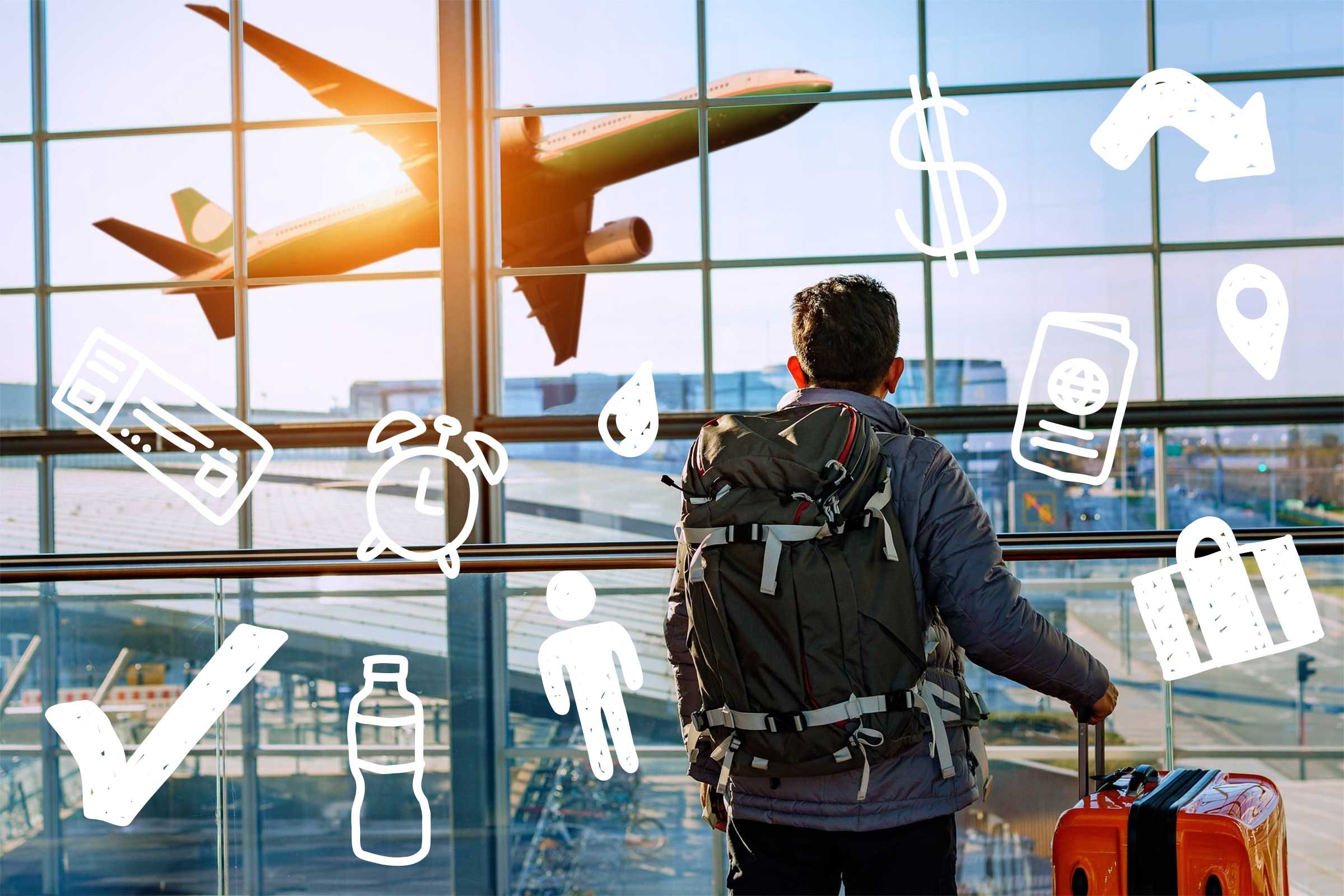 Male tourist is standing in airport and looking at aircraft flight through window.