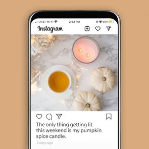 A candle glows alongside a cup of tea and white pumpkins on a marble surface, framed by soft lighting. Text: 