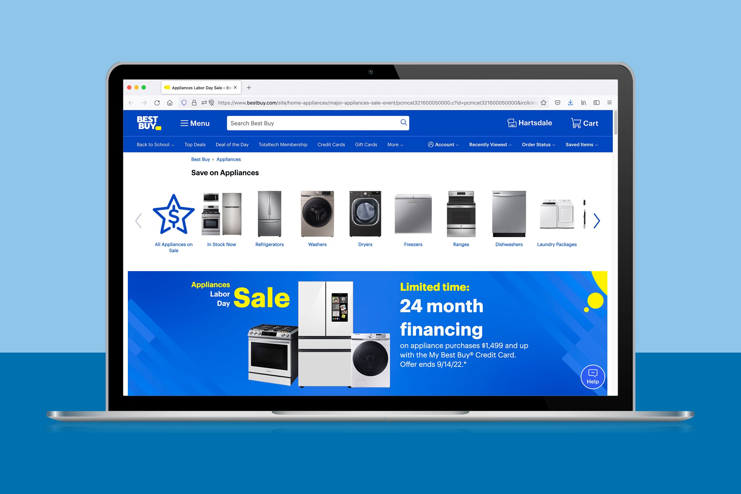 Laptop screen displays Best Buy's website, promoting an appliance sale with financing offers in a blue and white theme.