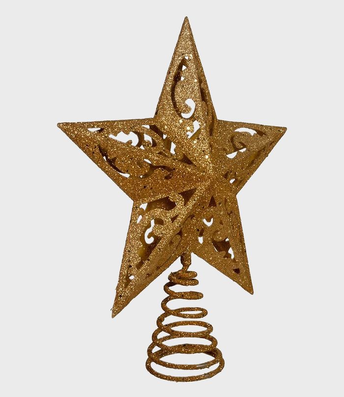 A glittery golden star sits atop a coiled spring base against a plain white background.