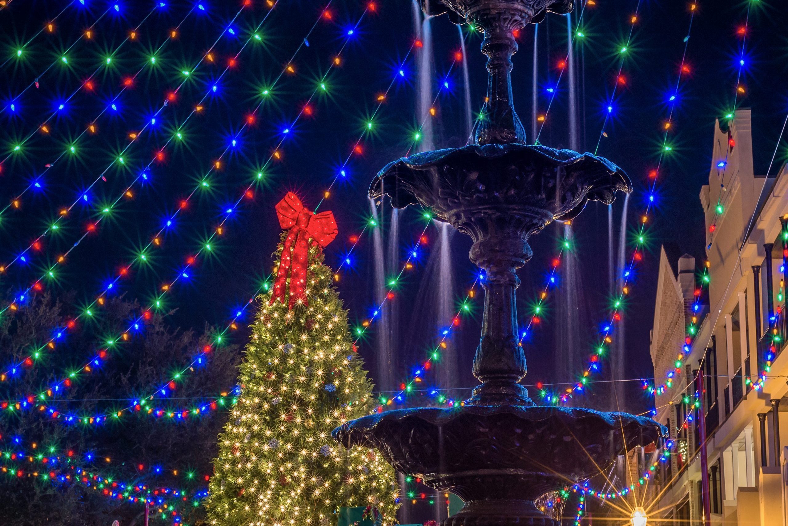 Fountain at night with holiday lights