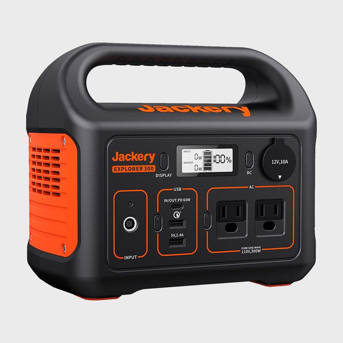 Portable power station displays usage metrics; connected ports available. It is in a neutral setting with orange and black coloring. Text: 