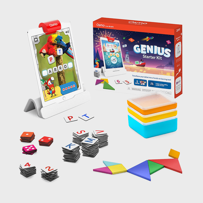 Tablet displaying spelling game with colorful tiles, blocks, and tangram pieces, next to a box labeled 