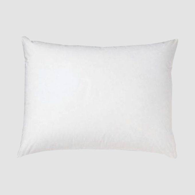 A rectangular white pillow lies flat on a plain gray background.
