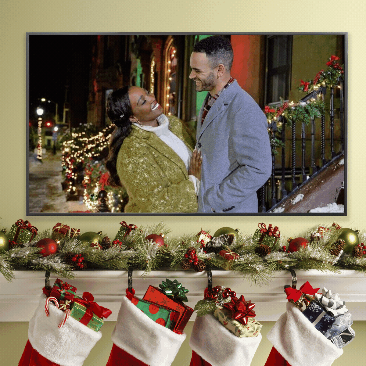A couple smiles at each other, standing on a festively decorated street. Below, a mantle is adorned with stockings and Christmas decorations.