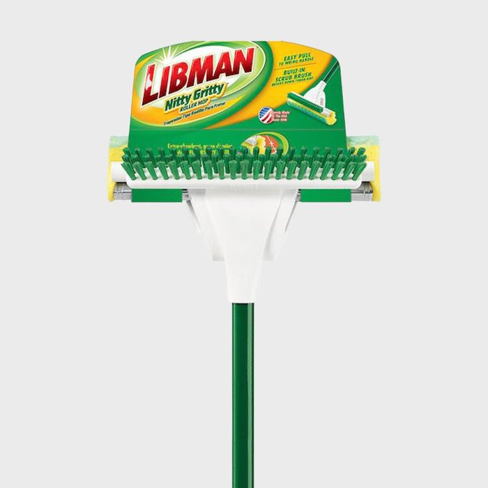 Mop with green scrub brush extends attached to white and green handle, shown against a plain background. Packaging reads 