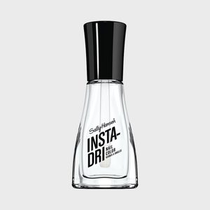 Clear nail polish bottle sits upright, labeled 