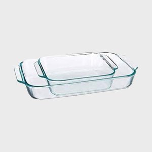 Two stacked, clear glass baking dishes with handles, positioned on a plain light gray background.