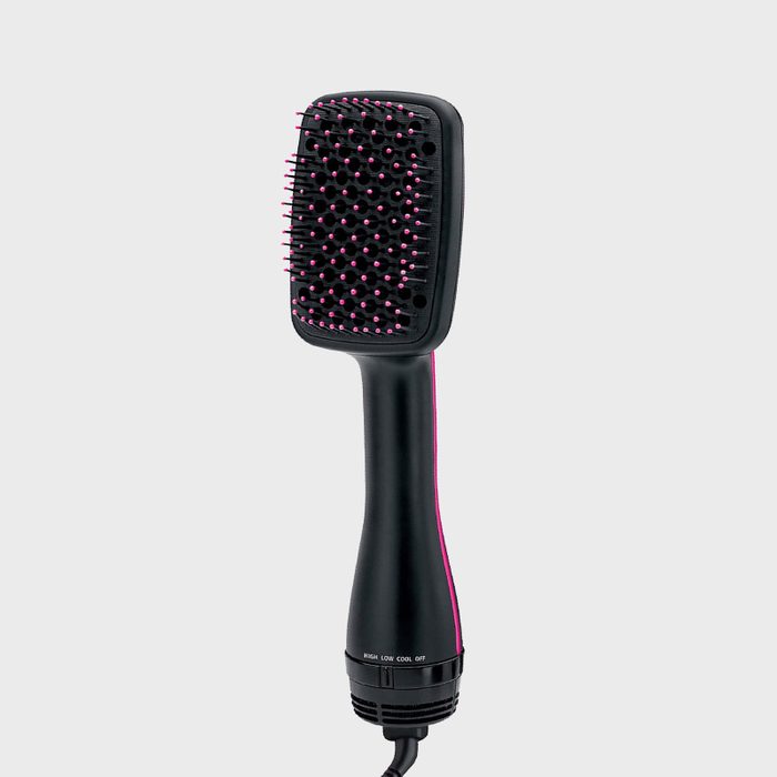 Brush, with pink-tipped bristles, stands vertically in a neutral background. Text on the handle reads 