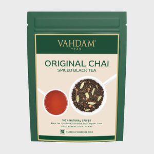 A green package displays Vahdam Original Chai, Spiced Black Tea, with images of brewed tea and tea leaves, labeled 