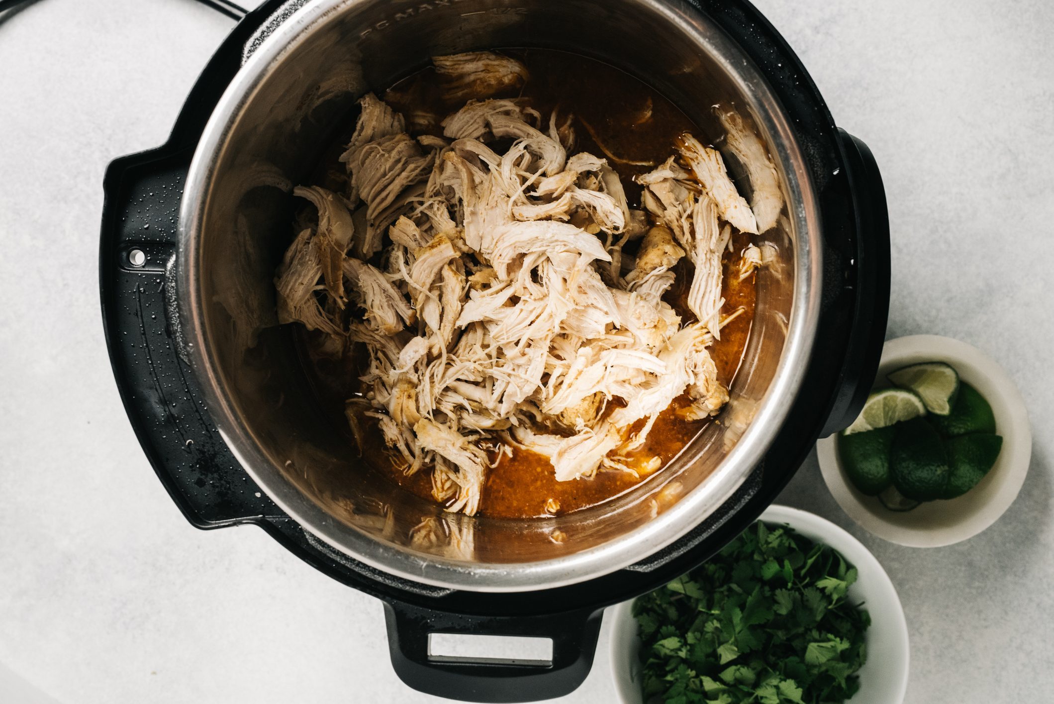 Shredded spiced chicken inside of an Instant Pot