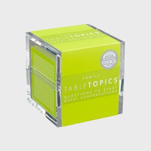 A clear cube holds conversation starter cards, showcasing the text 