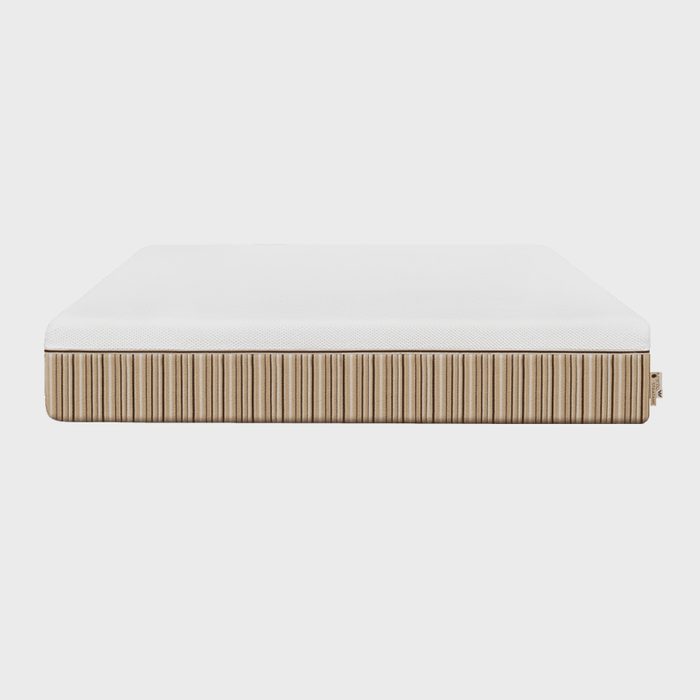 Mattress resting, featuring a white top and striped beige sides, against a plain white background.
