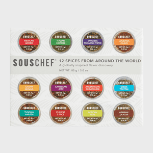 Twelve spice containers are arranged in a grid, showcasing flavors like Mexican Adobo and Greek Tzatziki. Packaging promotes 