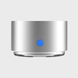 Silver metallic cylinder with blue button illuminated, set against a plain gray background.